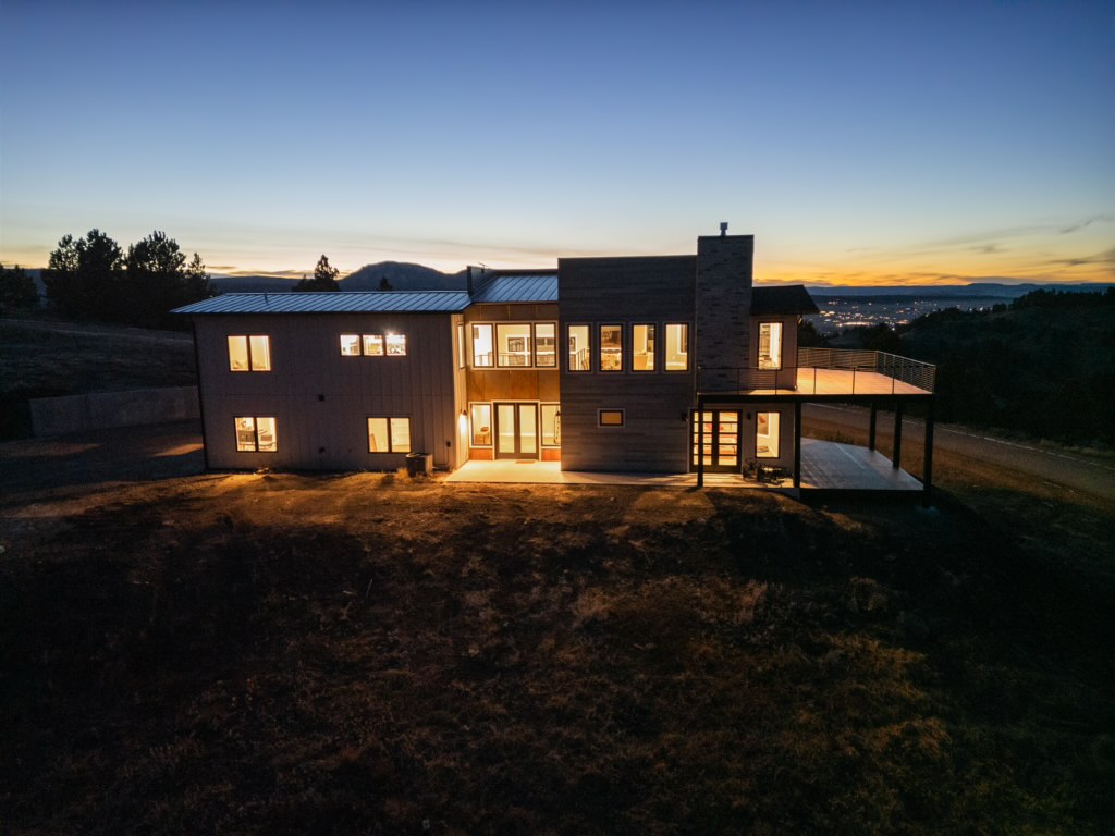 The rear facade glows at dusk